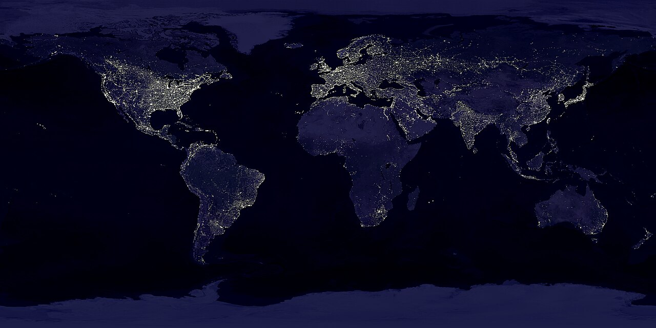 Composite image of Earth at night showing city lights across continents, a metaphor for 24/7 commodity markets.